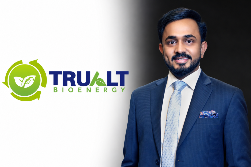 Vijay Nirani, Managing Director of TruAlt Bioenergy, alongside the company logo
